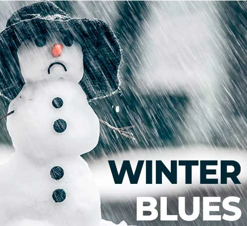 A snowman with a sad frown expression representing winter blues